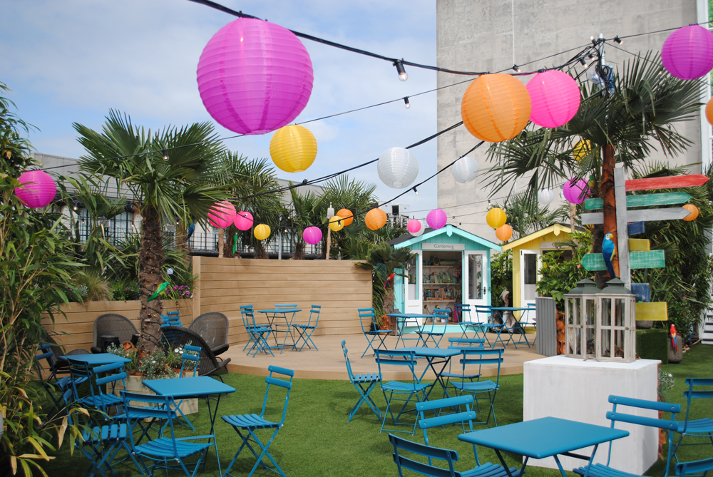 An area on the rooftop with tables and balloons